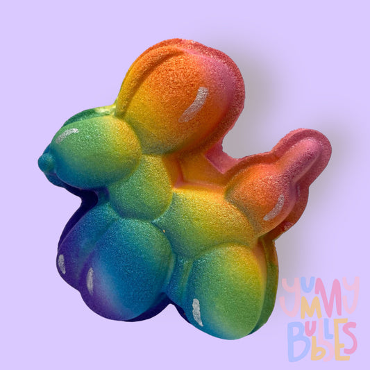 Balloon animal shaped bath bomb painted with a rainbow gradient and white