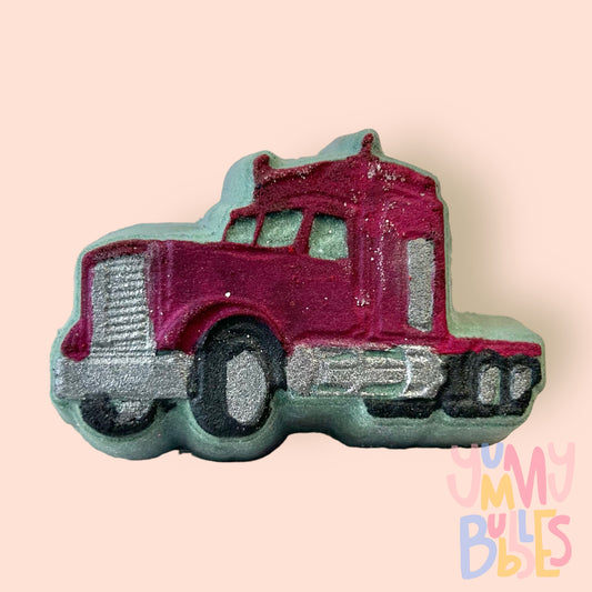 grey semi-truck shaped bath bomb with red, black, and grey paint