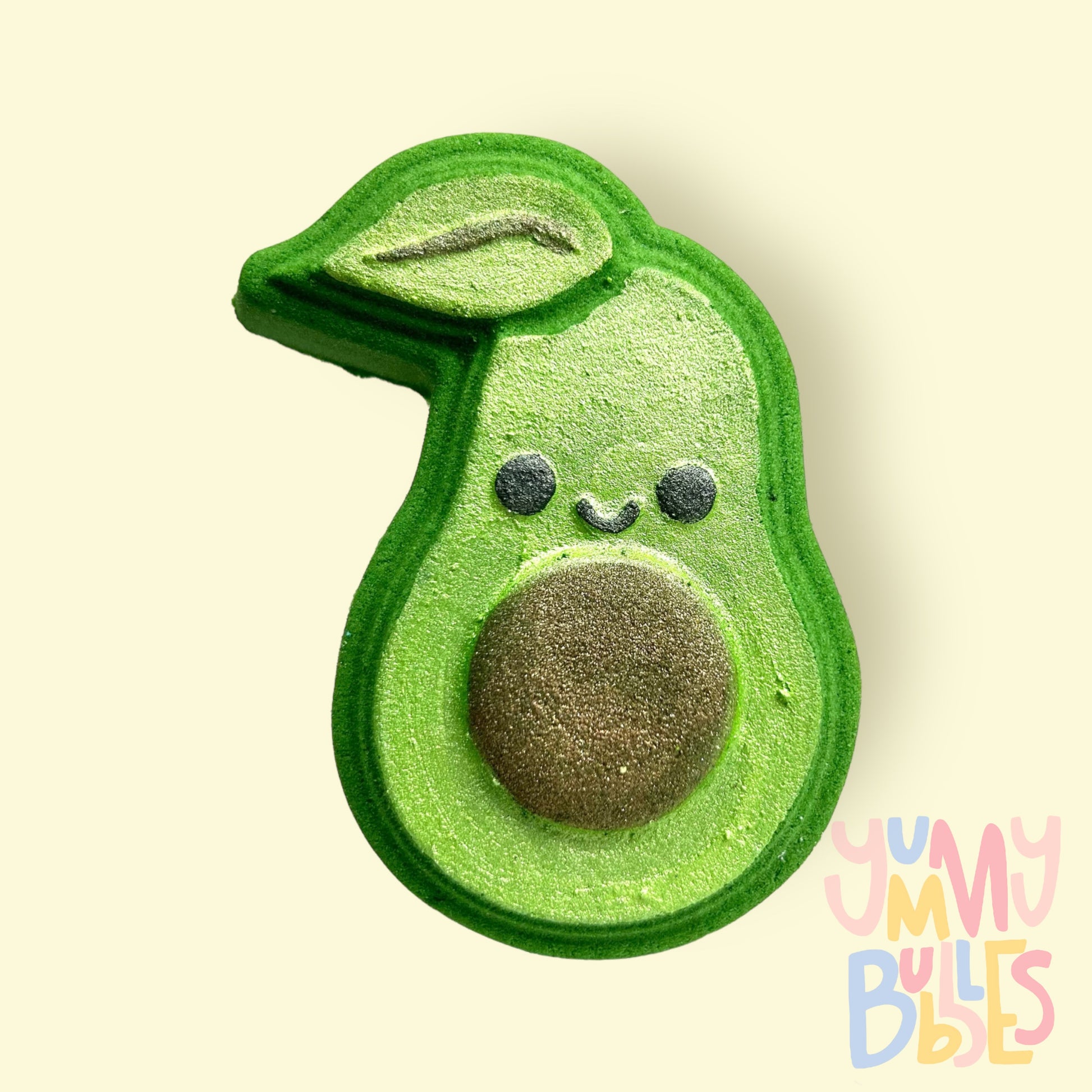 Green avocado shaped bath bomb painted with light green, brown, and black