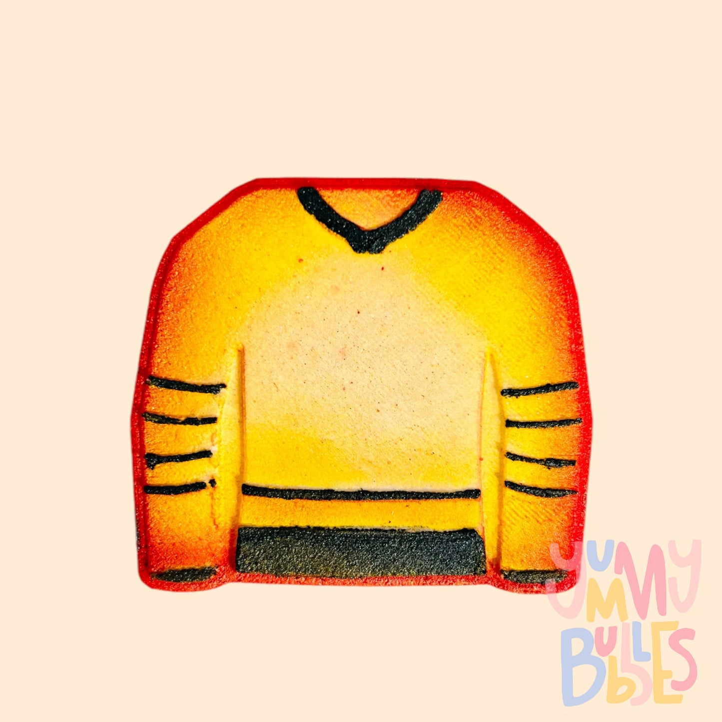 Hockey jersey shaped bath bath bomb painted with a red, orange, and yellow gradient with black lines