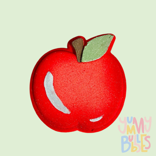 Red apple shaped bath bomb with white , green, and brown painted details