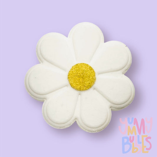 White daisy shaped bath bomb with a yellow painted center