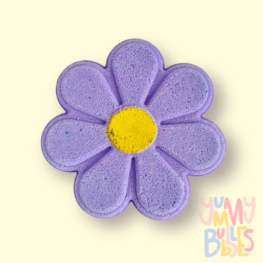 purple daisy shaped bath bomb with a yellow painted center