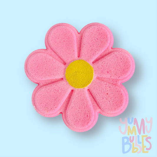 pink daisy shaped bath bomb with a yellow painted center