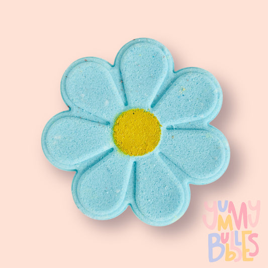 blue daisy shaped bath bomb with a yellow painted center