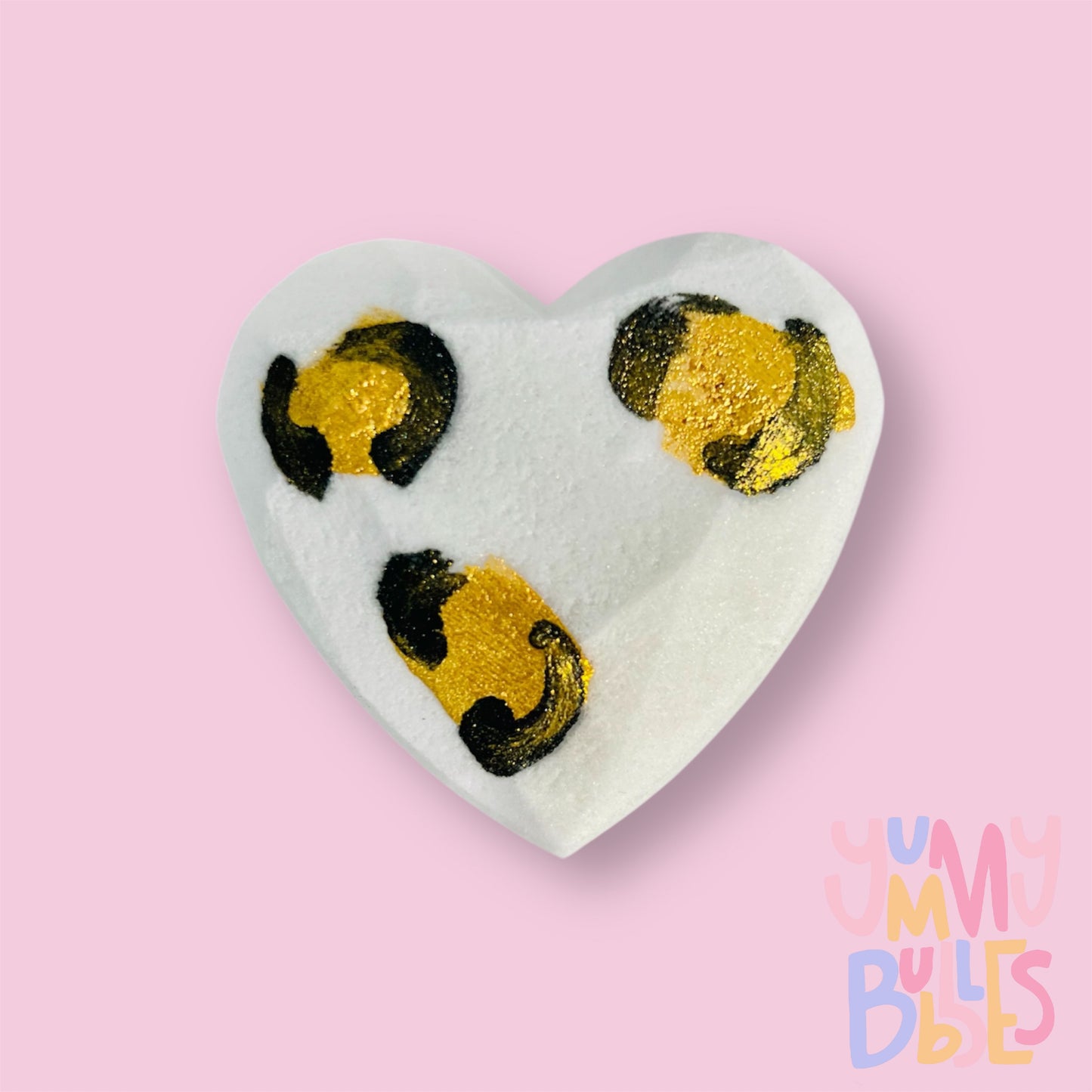 White Geometric heart shaped bath bomb with a painted leopard print design in gold and black