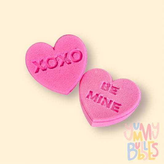 pink candy gram shaped bath bomb with sweet messages such as xoxo, be mine, etc
