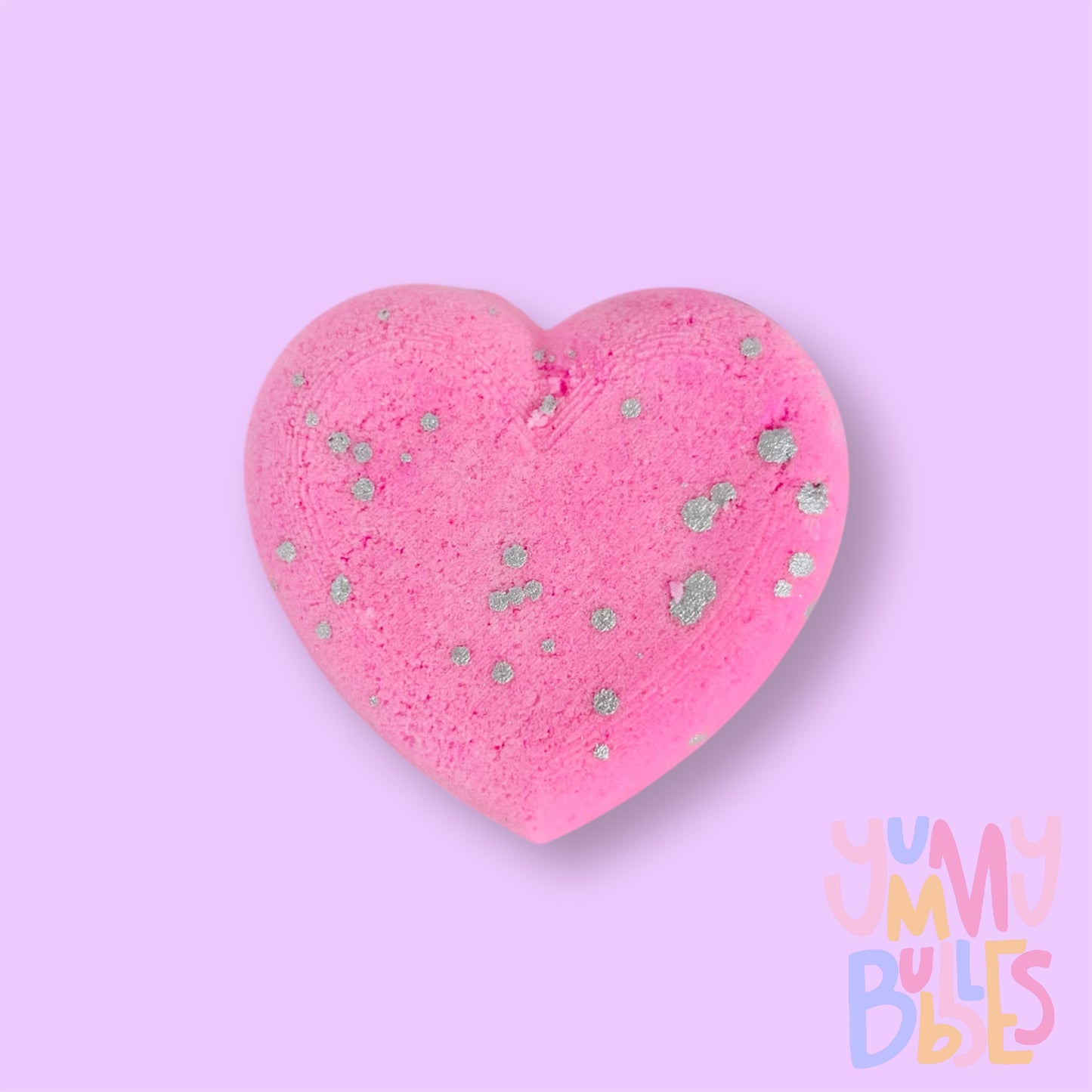 Pink heart shaped bath bomb with a white painted speckle