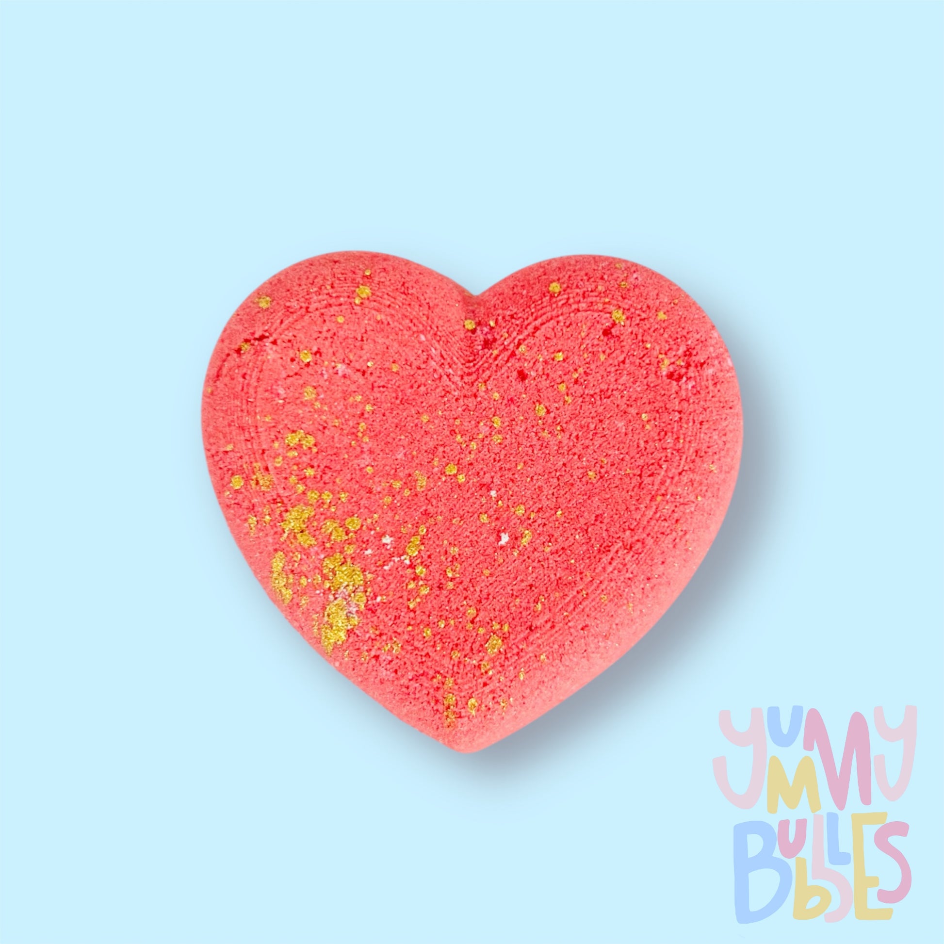 Red heart shaped bath bomb with a gold painted speckle