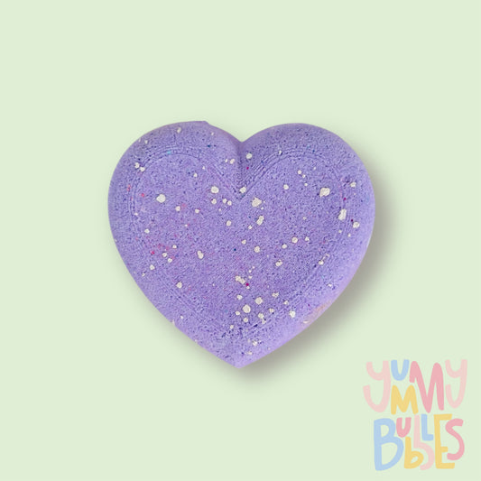 Purple heart shaped bath bomb with a white painted speckle