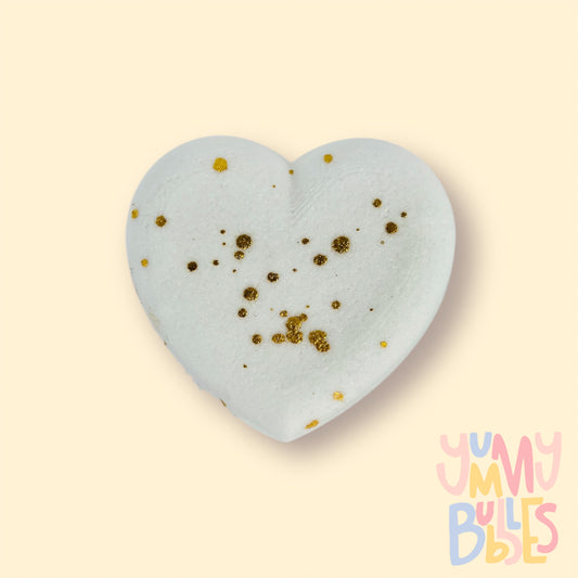 White heart shaped bath bomb with a gold painted speckle