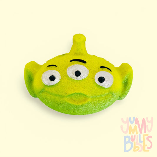 green toy story alien shaped bath bomb painted with white and black and highlighted with dark green paint