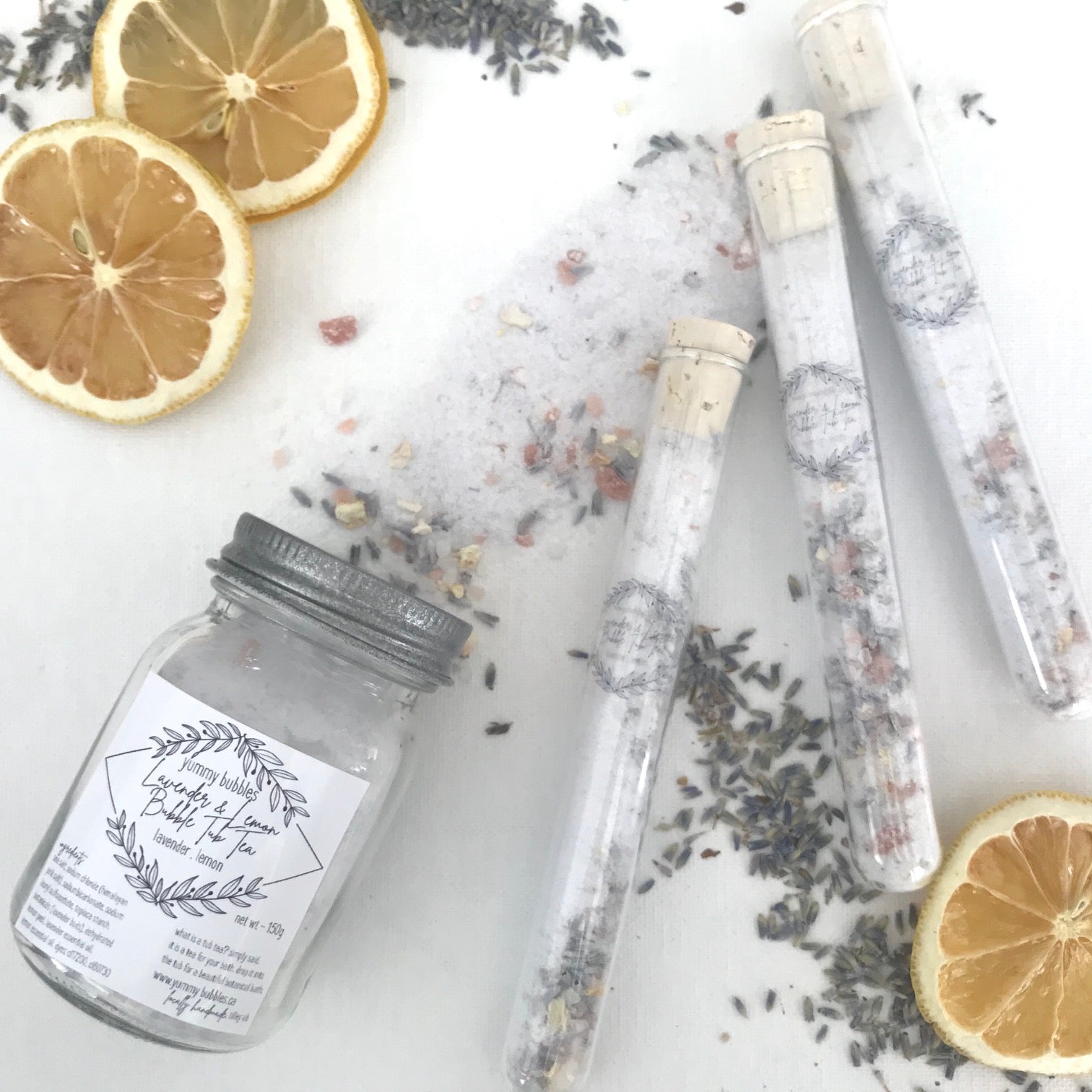 Light purple bath bomb dust and lavender petals mixed in clear test tubes or mason jars