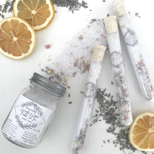 Light purple bath bomb dust and lavender petals mixed in clear test tubes or mason jars