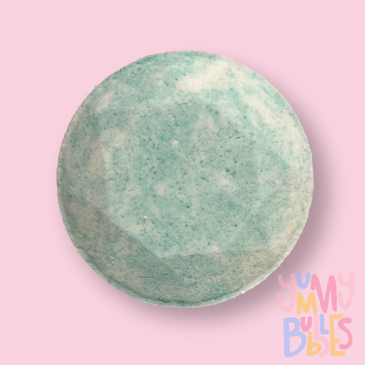 Circular shaped shower bomb colored with light blue and white